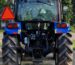 A blue tractor parked on a rural road in Smithville, Ohio, USA